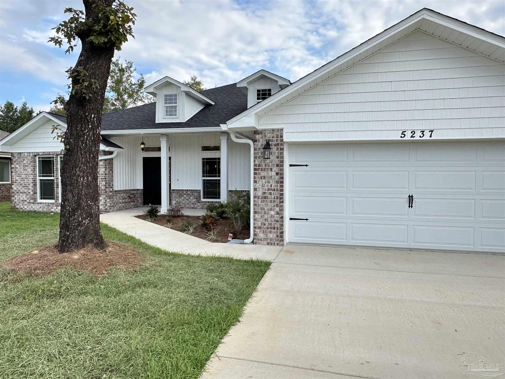 5214 Barnett Road Milton, FL 32583 - Photo 3 of 22 a view of a white house next to a yard with palm trees