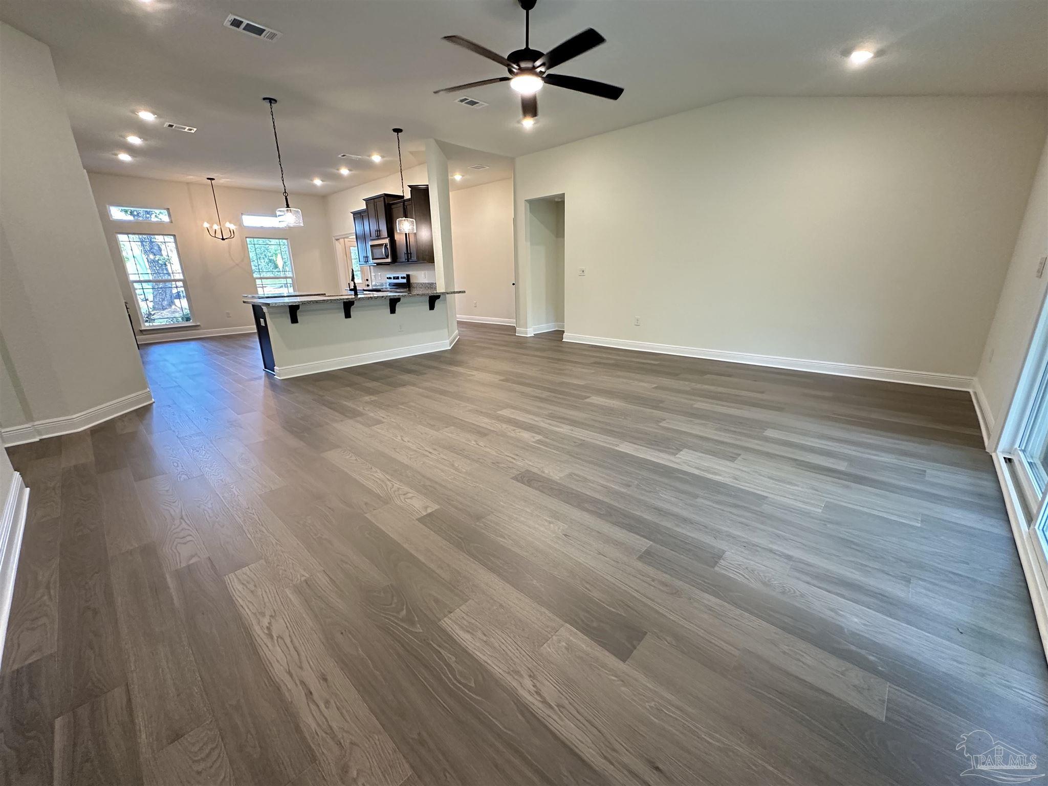 5214 Barnett Road Milton, FL 32583 - Photo 8 of 22 a view of an empty room with kitchen and a window