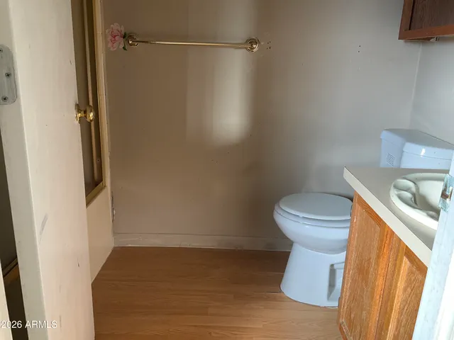 a white toilet sitting next to a sink