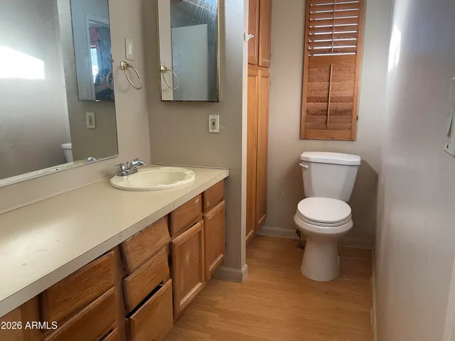 a bathroom with a sink a toilet and mirror