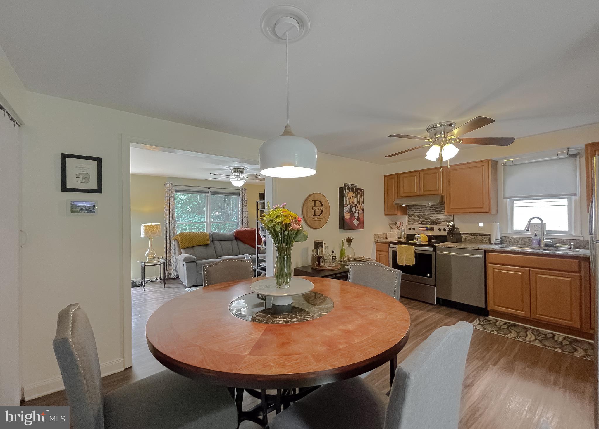 916 Crystal Rock Road Lusby, MD 20657 - Photo 16 of 44 a very nice looking dining room with kitchen island a table and chairs
