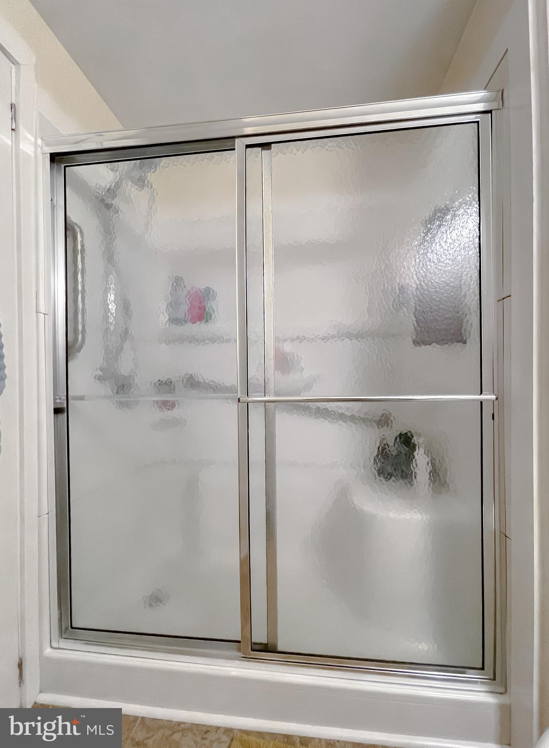 916 Crystal Rock Road Lusby, MD 20657 - Photo 24 of 44 a bathroom with a glass shower door