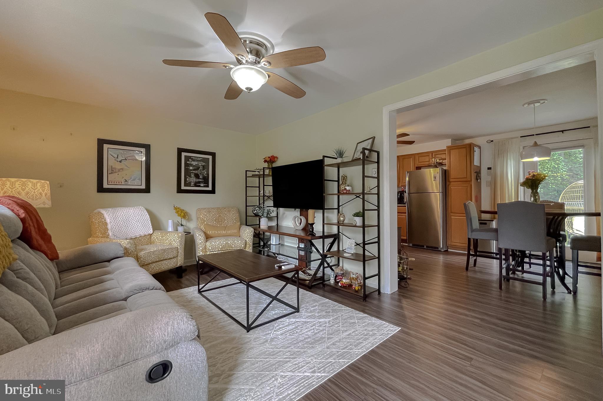 916 Crystal Rock Road Lusby, MD 20657 - Photo 7 of 44 a living room with furniture wooden floor and a flat screen tv