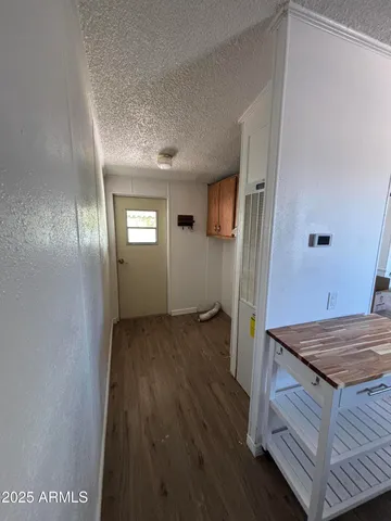 a view of hallway with wooden floor