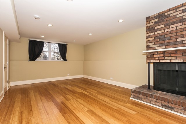 1172 North Old Bridge Road Palatine, IL 60067 - Photo 12 of 27 an empty room with wooden floor and a fireplace
