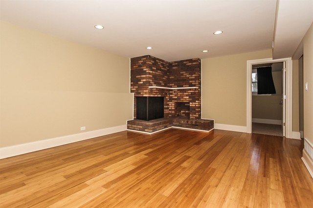 1172 North Old Bridge Road Palatine, IL 60067 - Photo 14 of 27 an empty room with wooden floor and fireplace