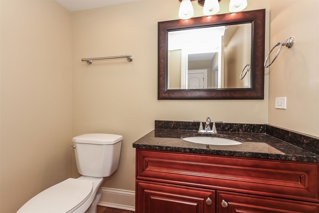 1172 North Old Bridge Road Palatine, IL 60067 - Photo 15 of 27 a bathroom with a toilet a sink and mirror