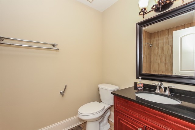 1172 North Old Bridge Road Palatine, IL 60067 - Photo 21 of 27 a bathroom with a granite countertop sink mirror vanity and toilet