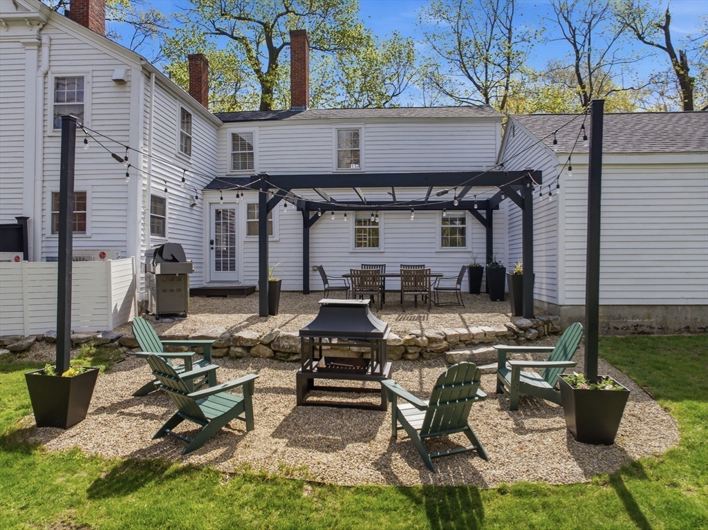 5 Great Road Bedford, MA 01730 - Photo 29 of 42 a view of a chairs and table in the back yard of the house