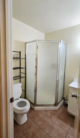 a bathroom with a toilet a sink and shower