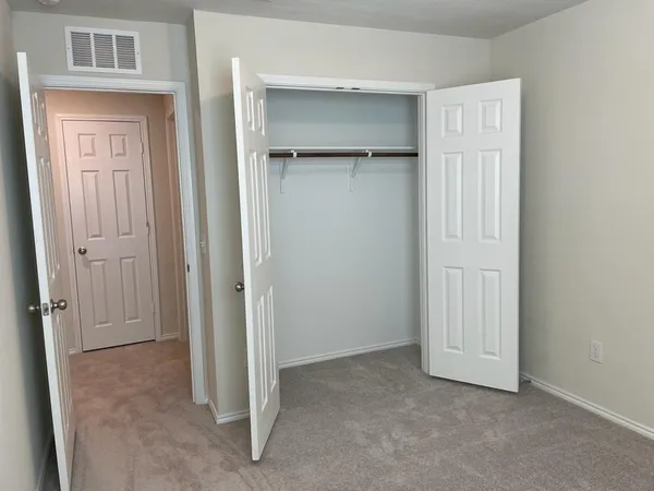 an empty room with closet area