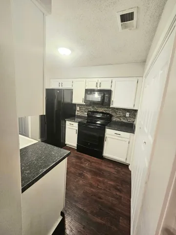 a kitchen with a refrigerator a stove and a sink