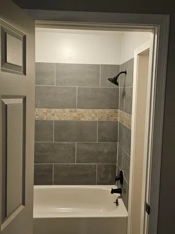 a bathroom with a bathtub and shower