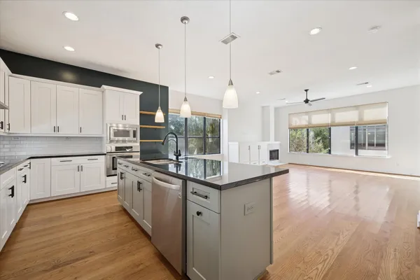 a kitchen with stainless steel appliances granite countertop a stove and cabinets