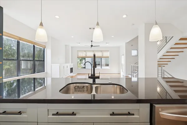 a kitchen with a sink a counter space and a window