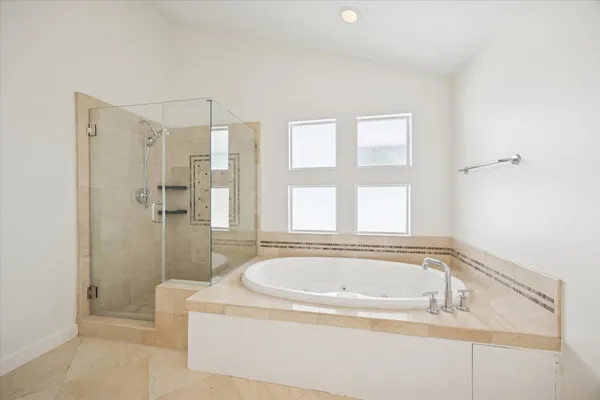 a white bath tub sitting next to a shower