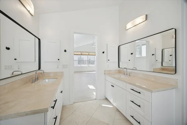 a bathroom with a granite countertop sink mirror and double