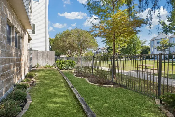 a view of a yard with a wooden fence
