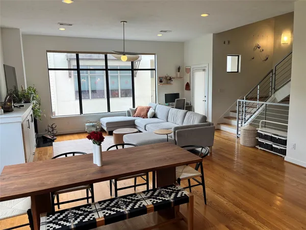 a kitchen with stainless steel appliances granite countertop table chairs and wooden floor