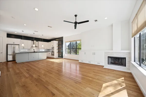 a view of an empty room with a fireplace and a window