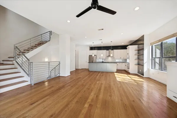 a view of empty room with wooden floor and windows