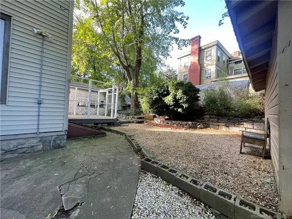 a view of a house with backyard and sitting area