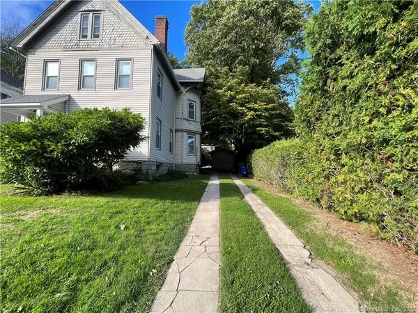 a front view of a house with a yard
