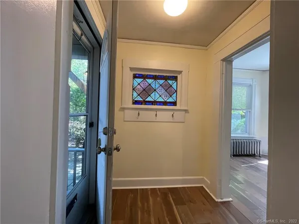 a view of room with window and wooden floor