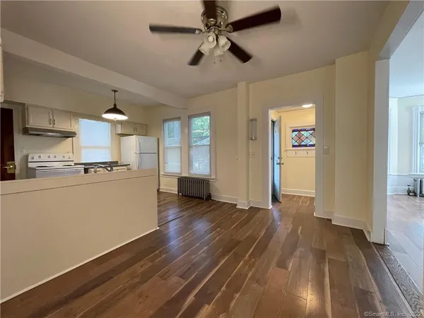 a view of a kitchen with wooden floor and a sink