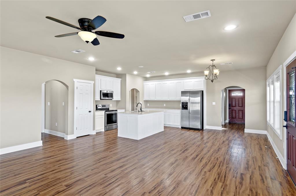 395 Yacht Club Road Oak Point, TX 75068 - Photo 23 of 23 Kitchen featuring arched walkways, white cabinets, recessed lighting, stainless steel appliances, and open floor plan