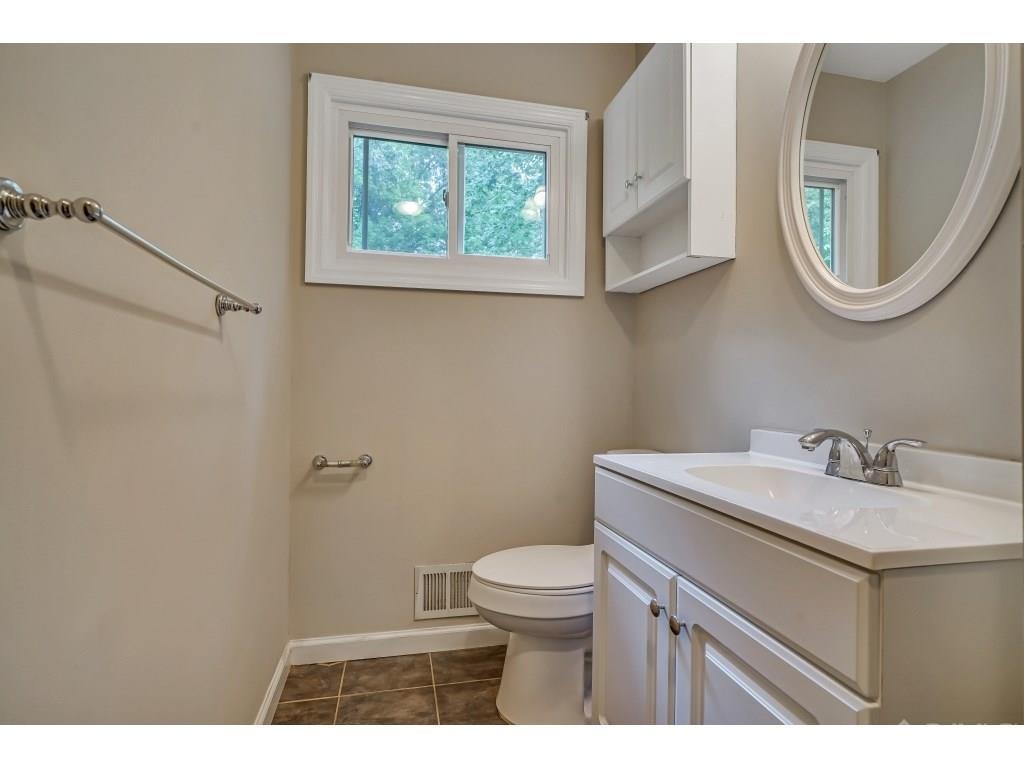 164 Princeton Road Old Bridge, NJ 08859 - Photo 8 of 19 a bathroom with a toilet a sink and a mirror