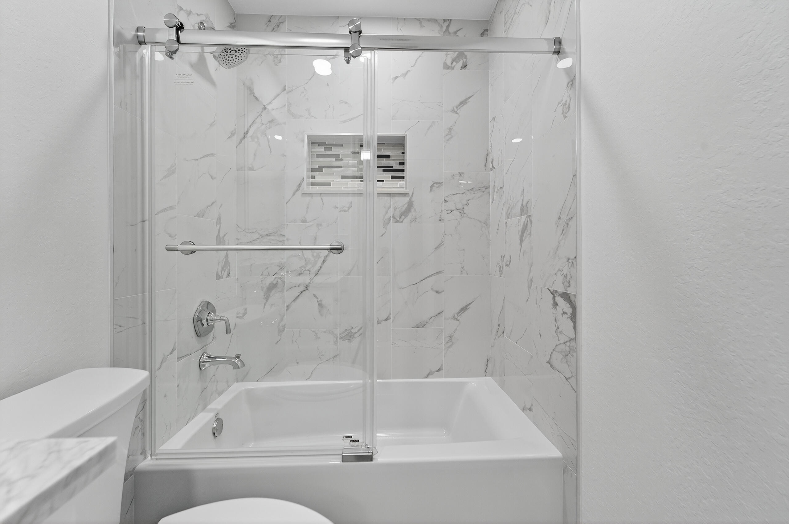 6830 2nd Street Jupiter, FL 33458 - Photo 12 of 34 a bathroom with a shower and a bath tub