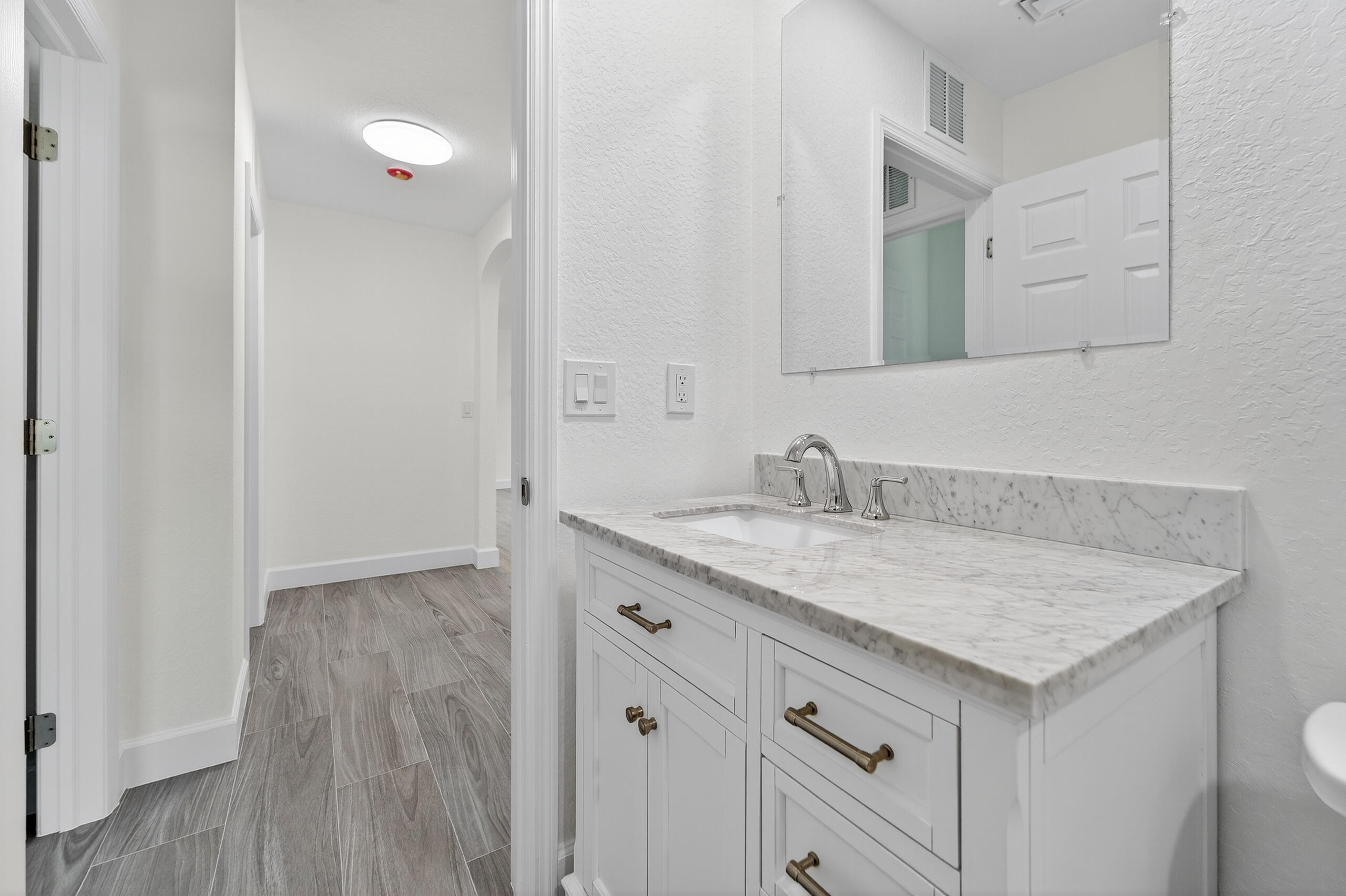 6830 2nd Street Jupiter, FL 33458 - Photo 13 of 34 a bathroom with a granite countertop sink and a mirror
