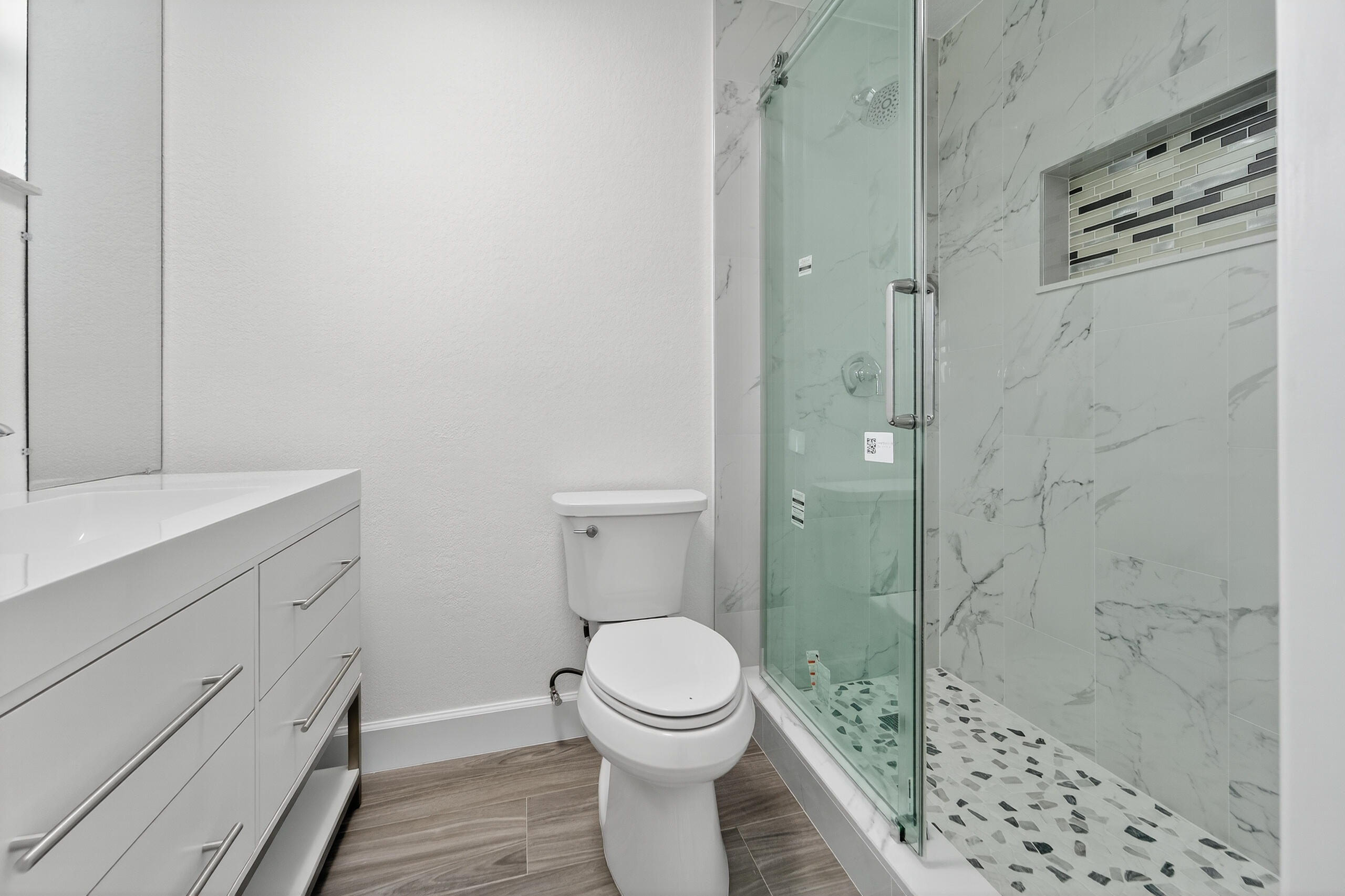 6830 2nd Street Jupiter, FL 33458 - Photo 16 of 34 a bathroom with a toilet a sink and shower