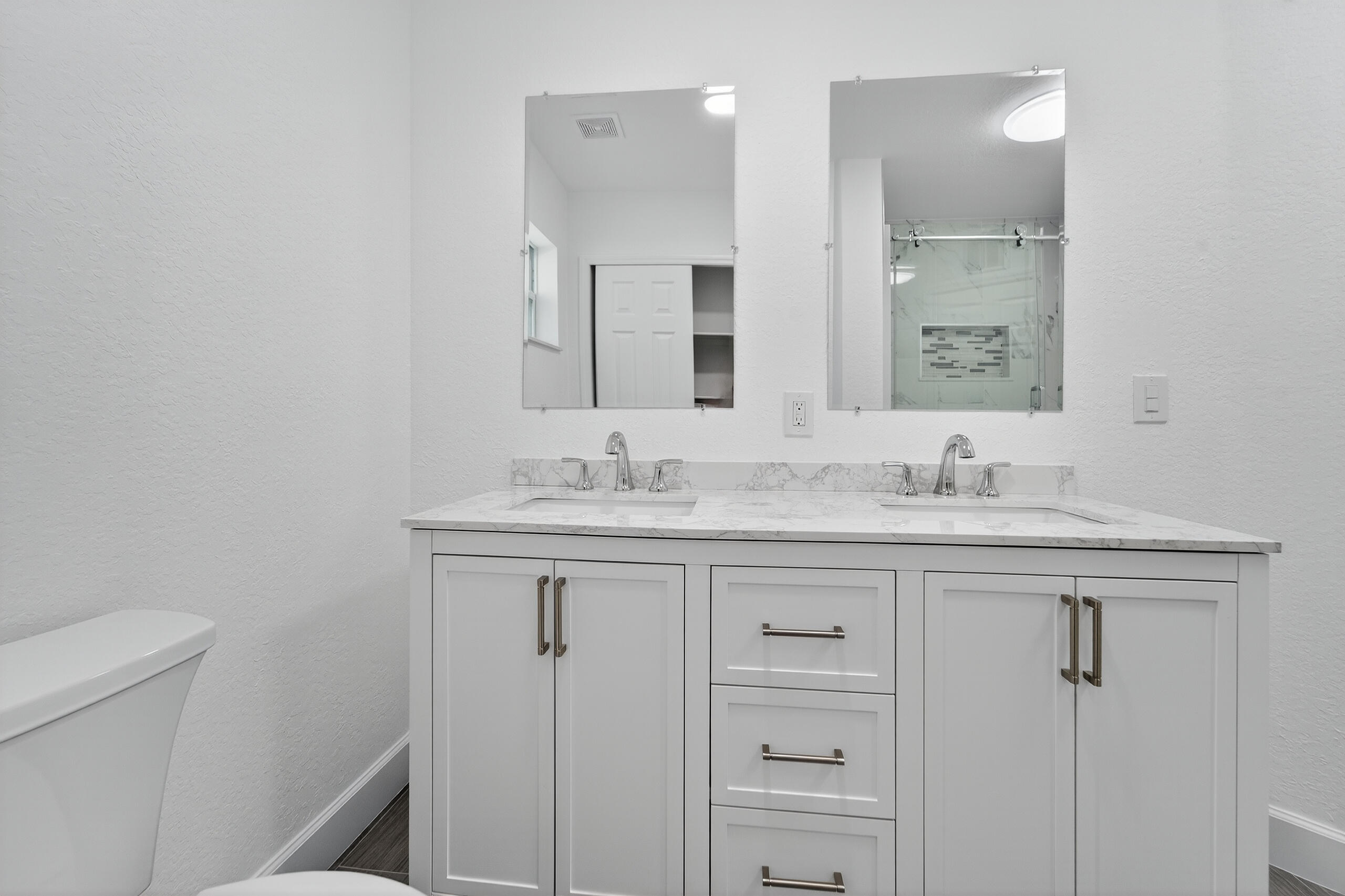 6830 2nd Street Jupiter, FL 33458 - Photo 21 of 34 a bathroom with a granite countertop sink a toilet and a mirror
