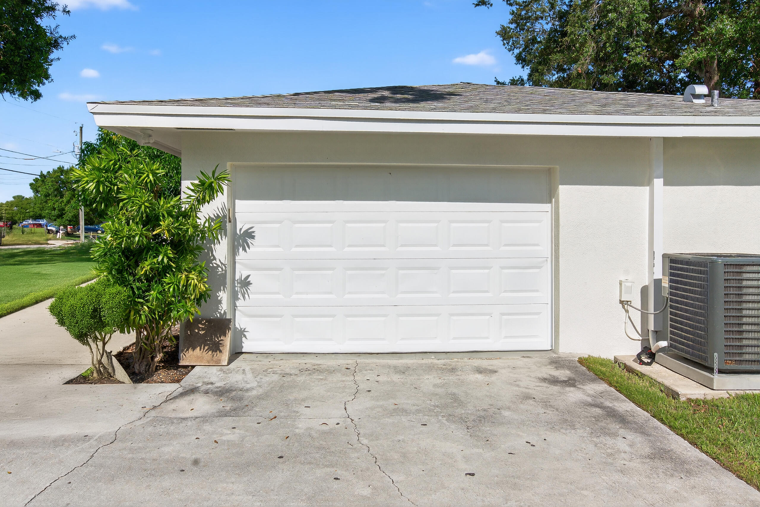 6830 2nd Street Jupiter, FL 33458 - Photo 23 of 34 a front view of a house with a yard and garage