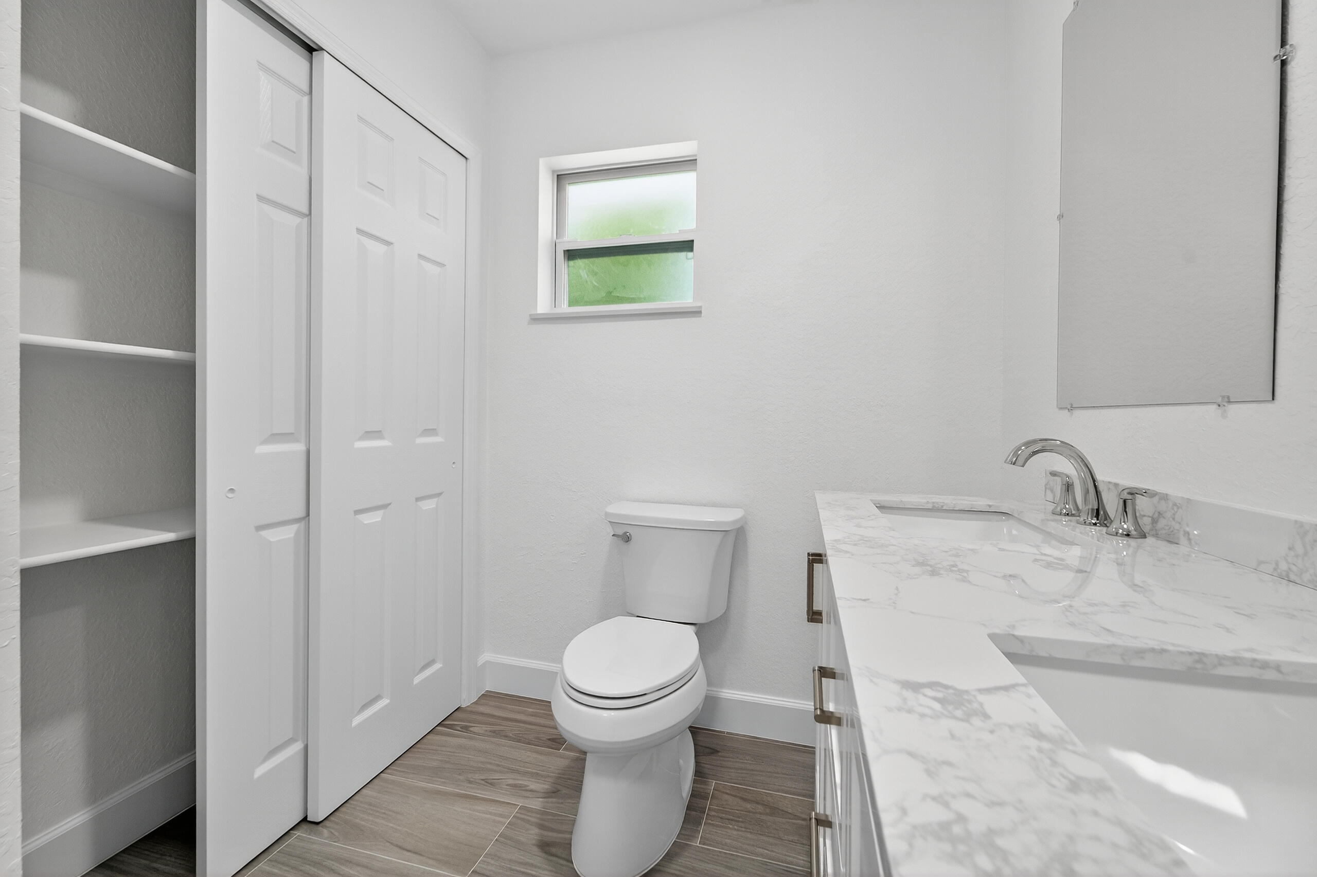 6830 2nd Street Jupiter, FL 33458 - Photo 26 of 34 a bathroom with a granite countertop toilet and a sink