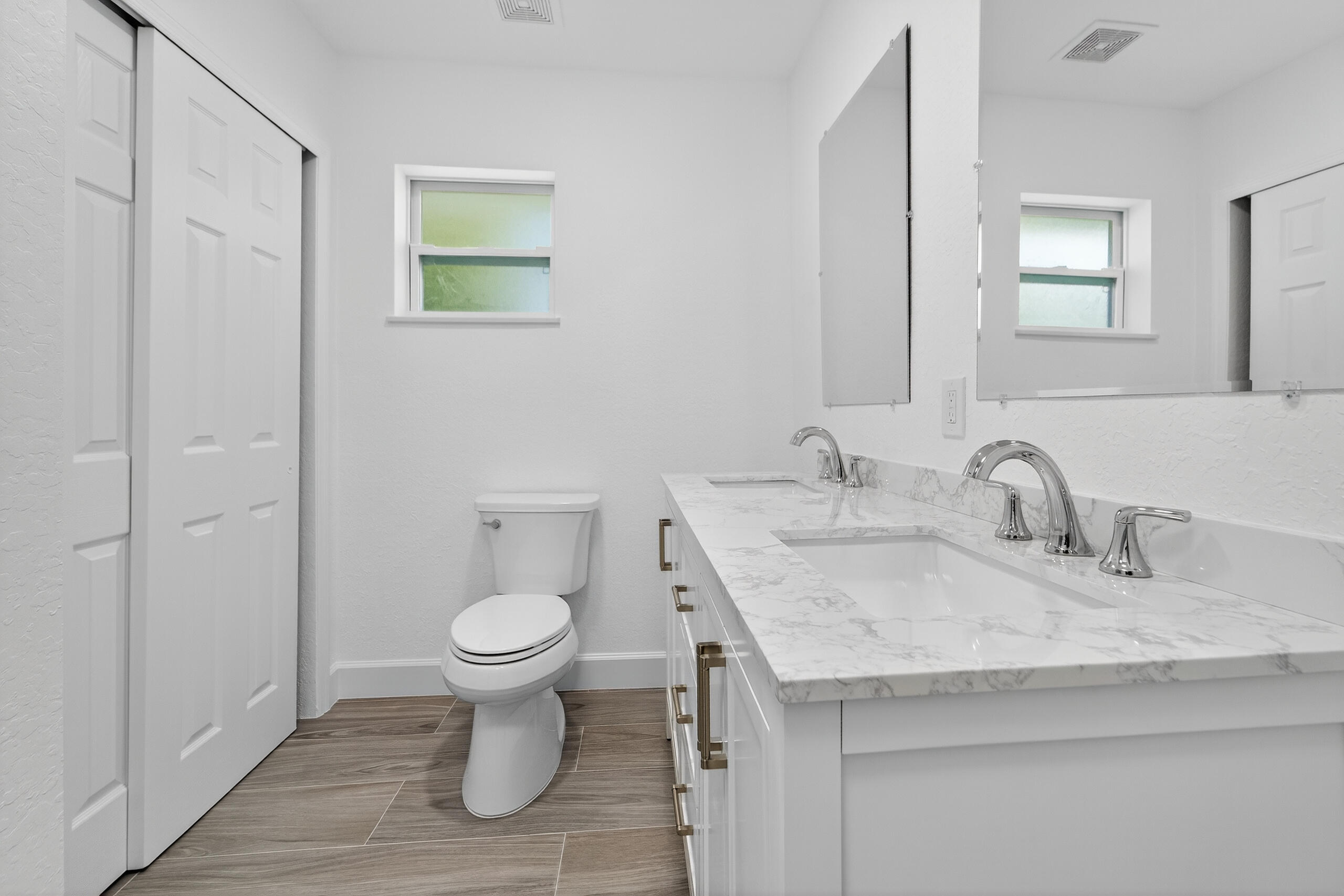 6830 2nd Street Jupiter, FL 33458 - Photo 27 of 34 a bathroom with a granite countertop toilet and a sink