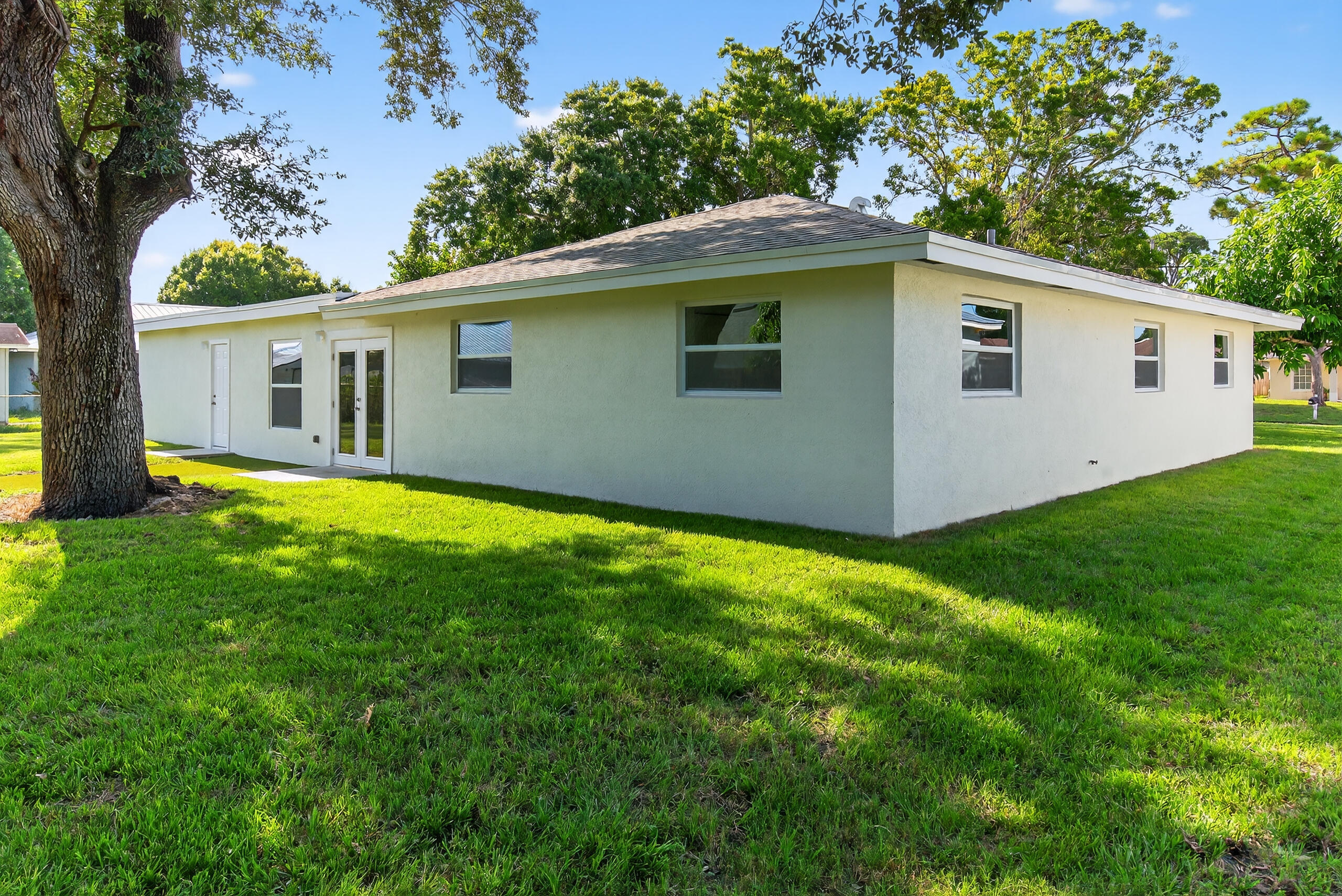 6830 2nd Street Jupiter, FL 33458 - Photo 31 of 34 a house with green field in front of it