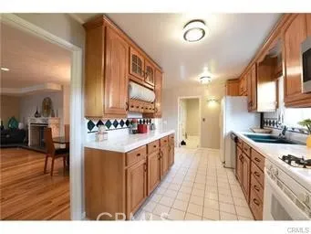 a large kitchen with stainless steel appliances granite countertop a stove and a sink