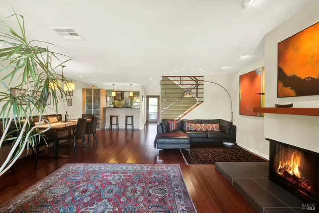 a living room with furniture wooden floor and a table