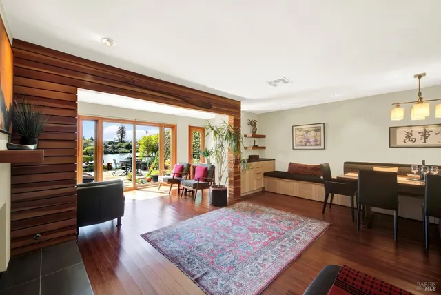 a living room with furniture a flat screen tv and a floor to ceiling window