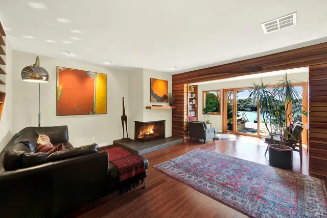 a living room with furniture a rug and a large window