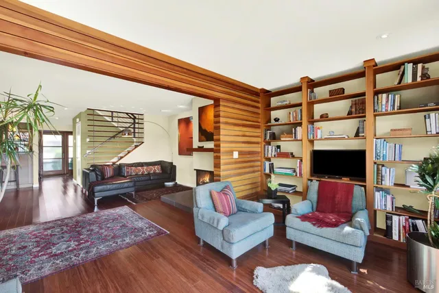 a view of a livingroom with furniture and hardwood floor