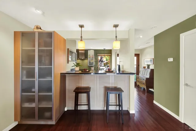 a bedroom with a bed and a dresser next to a window