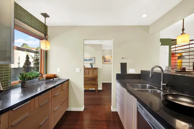 a bathroom with a granite countertop bathtub shower sink vanity and a toilet