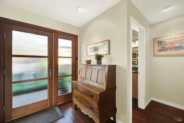 a view of a patio with couches table and chairs and potted plants