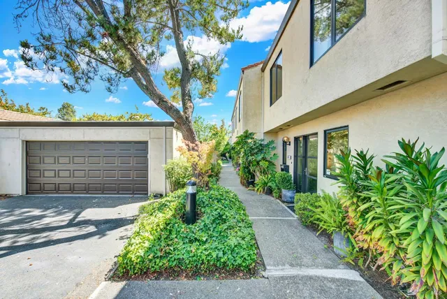 a glass door with yard in front of it