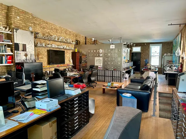 a living room with lots of furniture hardwood and a chandelier