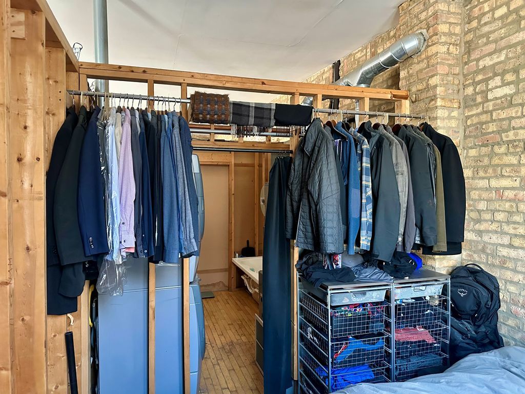 1906 North Milwaukee Avenue Chicago, IL 60647 - Photo 19 of 23 a view of walk in closet with clothes and shoes